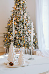 Elegant holiday decorations with a Christmas tree and candles in a cozy setting