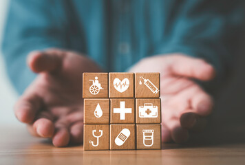 Businessman have giving healthcare icons which print screen on wooden block cube for health wellness and insurance concept.
