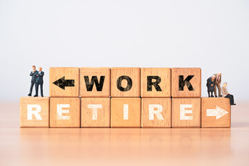 Businessmen and old persons standing on wooden block cube with work and retirement concept.