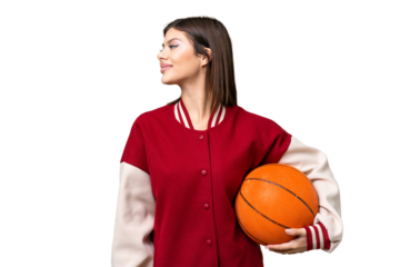 Young Russian woman playing basketball over isolated chroma key background looking side