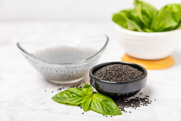 Basil seeds on textured wooden background. Close-up. Superfood. Ocimum basilicum. Organic basil seeds. selasih. Space for text. Copy space.