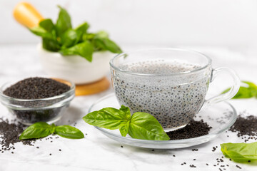 Basil seeds on textured wooden background. Close-up. Superfood. Ocimum basilicum. Organic basil seeds. selasih. Space for text. Copy space.