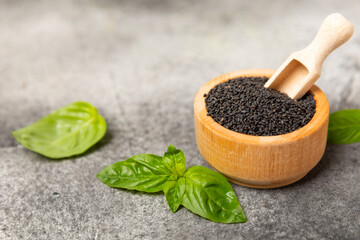 Basil seeds on textured wooden background. Close-up. Superfood. Ocimum basilicum. Organic basil seeds. selasih. Space for text. Copy space.