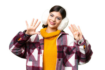 Young Russian woman wearing winter muffs over isolated chroma key background counting nine with...