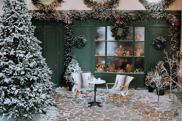 Cozy winter seating area adorned with holiday decorations and snow