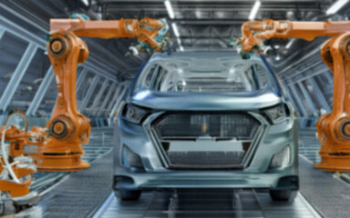 Fototapeta premium 自動車工場 にて 産業用 ロボット が 自動車 を 製造 【 自動車 産業 の 背景イメージ 】【 被写界深度 で ボケた 表現 】