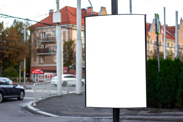 Vertical blank white street billboard in the city. Advertising banner with copy space. Mock up. Space for text