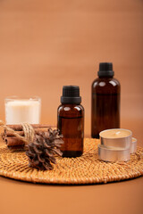 Amber Glass Essential Oil Bottle with Candles and Diffuser on Woven Mat for Spa and Relaxation