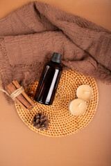 Amber Glass Essential Oil Bottle with Candles and Diffuser on Woven Mat for Spa and Relaxation