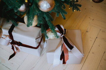 Beautifully wrapped presents beneath a Christmas tree in a cozy living room