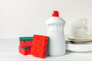 Colorful dish sponges on textured background. Kitchen sponge. Cleaning concept, cleaning service. Dishwashing liquid with clean and dirty dishes plate. Place for text, copy space. Wash the dishes.