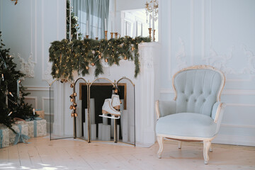 Cozy holiday living room featuring a decorated fireplace and elegant chair