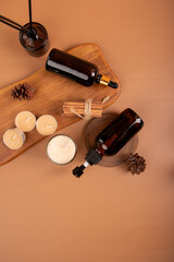 Flat Lay of Amber Dropper Bottles with Wooden Tray and Candles for Spa and Aromatherapy