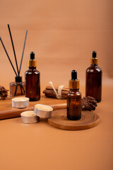 Flat Lay of Amber Dropper Bottles with Wooden Tray and Candles for Spa and Aromatherapy