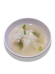 Boiled dumplings soup served in a small white bowl isolated on a white background