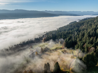 Aerial landscape photo with low level clouds on a fall morning in the border area between Germany and Austria with the Bregenz Forest Mountains, Vorarlberg, Austria , Bavaria, Germany