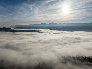 Aerial landscape photo with low level clouds on a fall morning in the border area between Germany and Austria with the Bregenz Forest Mountains, Vorarlberg, Austria , Bavaria, Germany