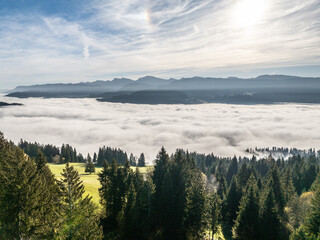 Aerial landscape photo with low level clouds on a fall morning in the border area between Germany and Austria with the Bregenz Forest Mountains, Vorarlberg, Austria , Bavaria, Germany