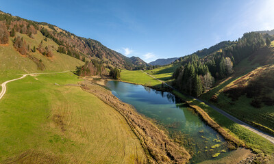 panoramic Aerial landscape photo of the Begenz Forest mountains with Lake Leckner in the Leckner Valley near Hittisau, Vorarlberg, Austrian Alps