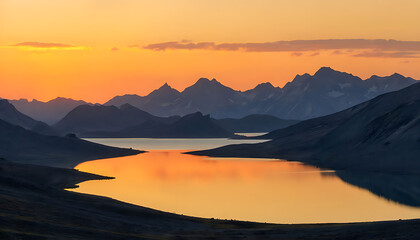 Obraz premium Sunset in the mountains at a calm lake - Sunset over the mountain reflection at golden hour, Calm mountain lake reflecting the sunset in the mountains, dawn