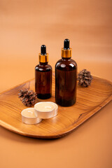 Amber Dropper Bottles on Wooden Tray with Candles and Linen for Spa and Skincare Product Display