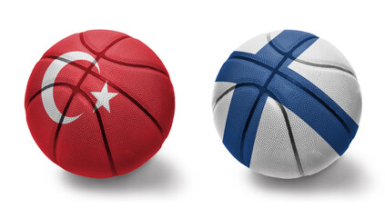 basketball balls with the national flags of finland and turkey on the white background.