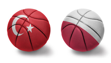 basketball balls with the national flags of poland and turkey on the white background.