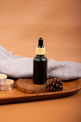 Black Dropper Bottles with Tea Lights and Natural Wood Decor for Spa and Skincare Branding Mockup