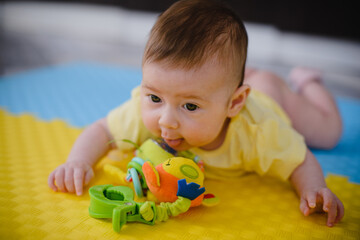 Portrait of a newborn baby. He looks at the camera and smiles. 3 months