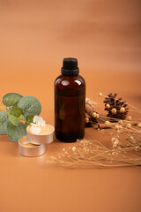 Amber Glass Bottle with Eucalyptus, Cinnamon, and Tealight Candle for Natural Skincare and Wellness Mockup