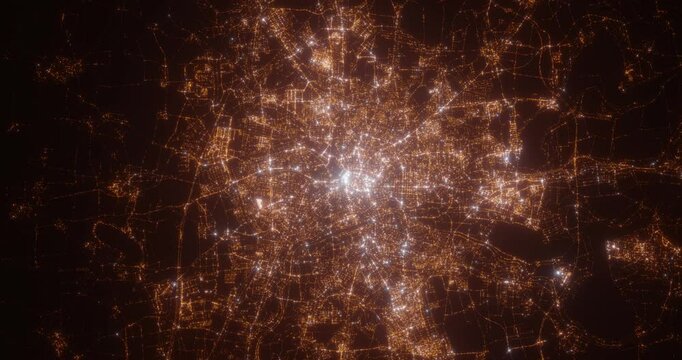 Leipzig (Germany) top view at night. Aerial view on modern city with lights. Camera is flying above the city, moving backward. Vertical video. The north is on the left side