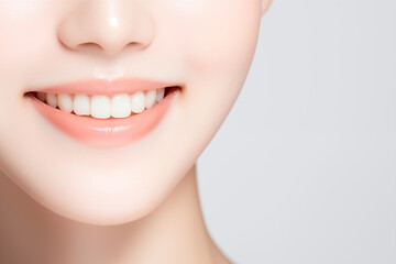 Obraz premium close-up of smiling woman with perfect white teeth on neutral background
