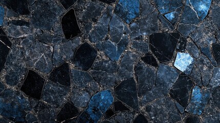 A close-up of dark blue and black marble pieces, showcasing a striking blend of textures and colors.