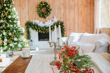 Festive living room decorated for Christmas with a glowing fireplace and tree