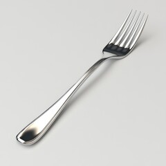 A shiny stainless steel fork rests on a light background, showcasing its sleek design and functional tines.