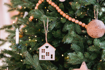 Decorated Christmas tree with handmade ornaments in cozy home