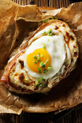 Croque madame sandwich, traditional french hot sandwich on baking paper, top view