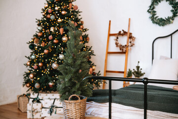 Cozy winter bedroom with Christmas tree and festive decorations