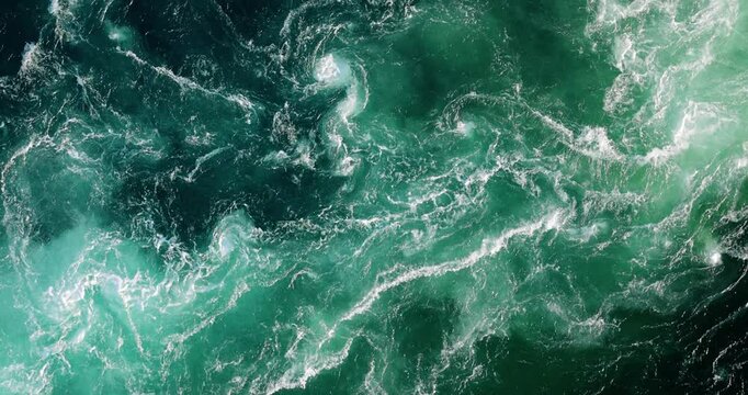 Blue waves of water of the river and the sea meet each other during high tide and low tide.