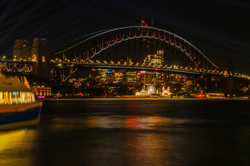 Illuminated night view on Sydney Harbor Bridge. The bridge was opened in 1932 and it is the tallest steel arch bridge in the world.