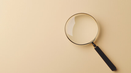 ベージュ背景に置かれた拡大鏡