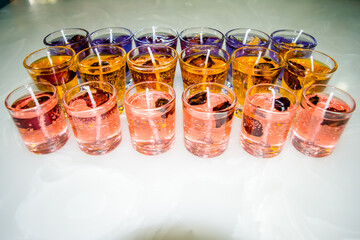 Gel candle in glass isolated on white background. set of colored gel candles. Candle in glass with many colored candles.