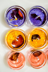 Gel candle in glass isolated on white background. set of colored gel candles. Candle in glass with many colored candles.