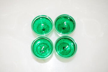 Gel candle in glass isolated on white background. set of colored gel candles. Candle in glass with many colored candles.