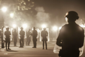 Fototapeta premium A group of police officers stand in a dark street