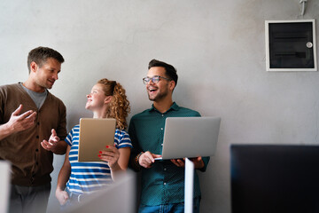 Group of young multi-ethnic startup business team collaborating on project in modern office