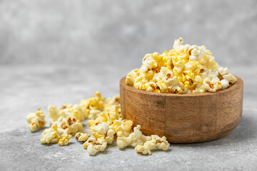 Salty popcorn on bright color background. Cinema and entertainment concept. Movie night with popcorn. Delicious appetizer, snack.Space for text, copy space. Banner