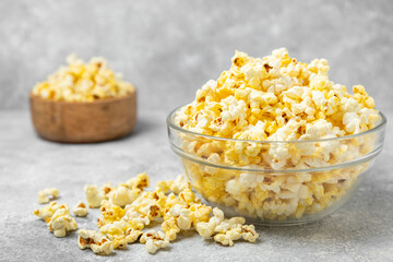 Salty popcorn on bright color background. Cinema and entertainment concept. Movie night with...