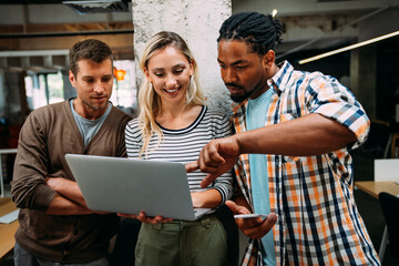Startup business team on meeting in modern bright office interior and working together