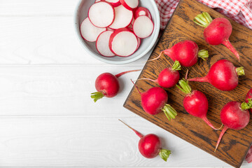 Fresh radish on textured wooden background. Organic natural garden radish slices. clipping root crop. Vegetables. Vegan. Diet products. Healthy food. Place for text. Copy space.